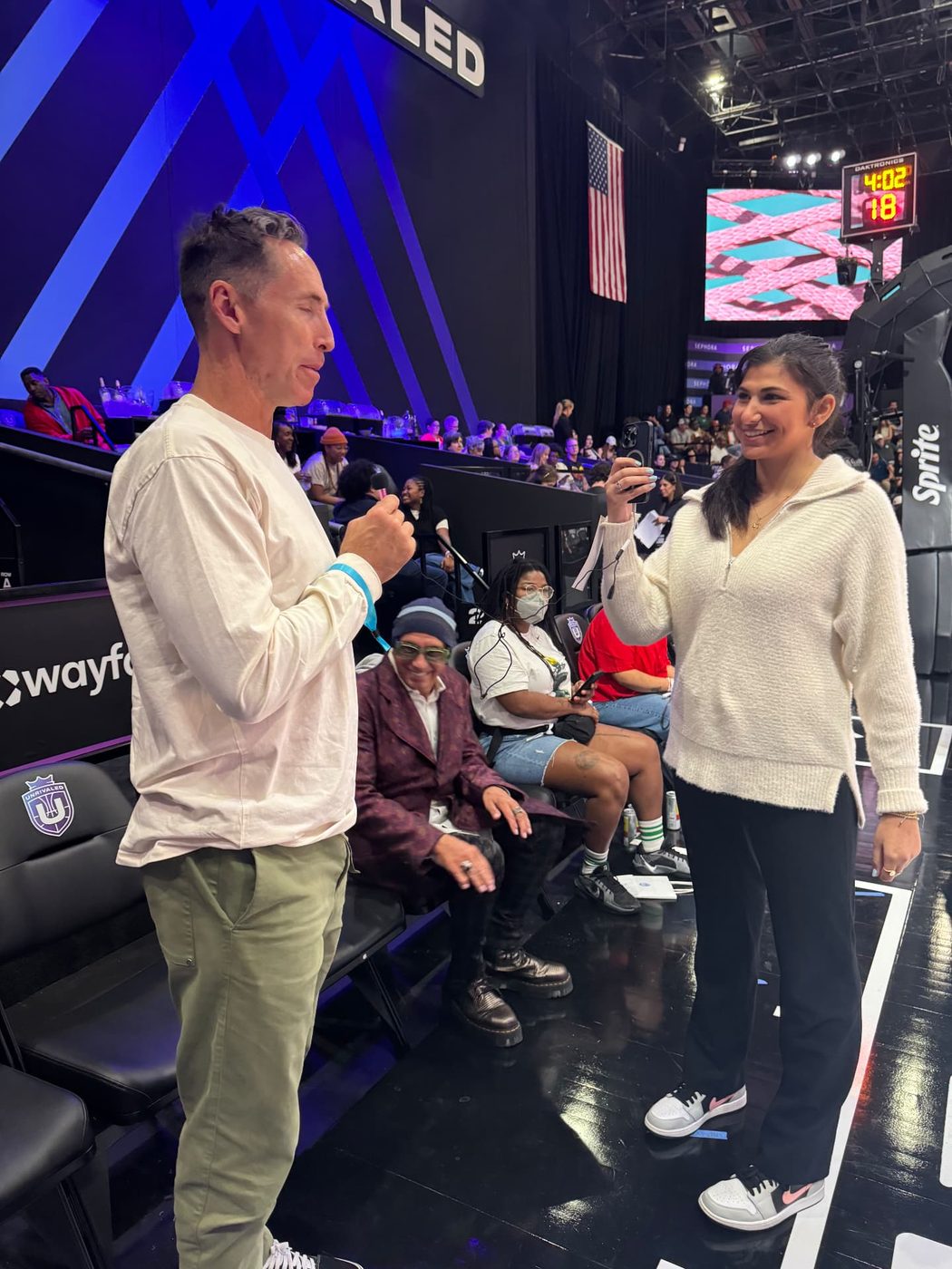 Reilly interviewing Steve Nash courtside at an Unrivaled game